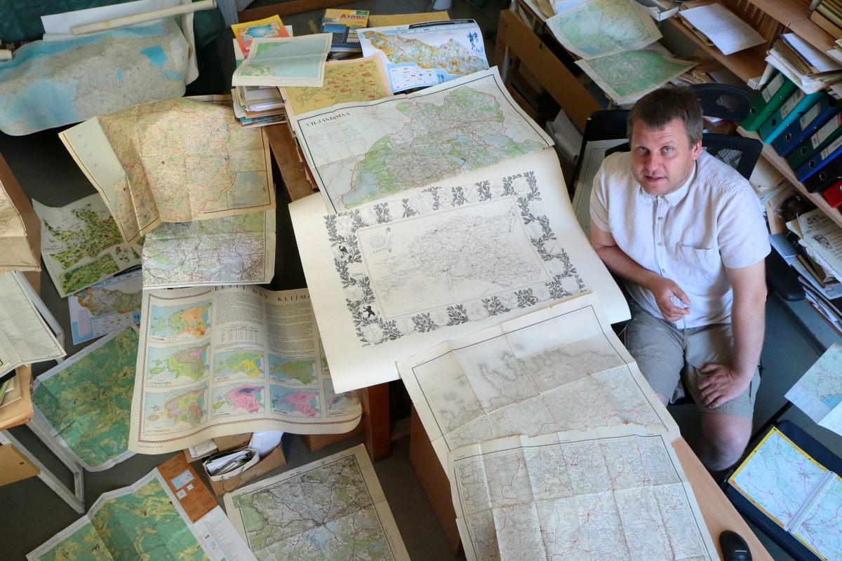 El profesor asociado y geógrafo Taavi Pae estudia de cerca los mapas de Estonia.