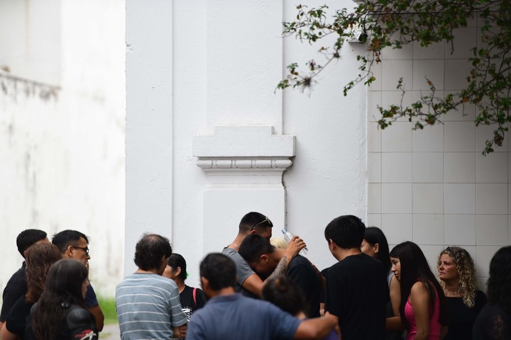 Abrazo y lágrimas frente al cementerio municipal por el crimen de Kim Gómez. Foto Mauricio Nievas