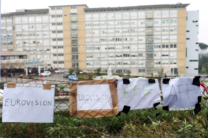 Signs with names of media outlets hang on a fence outside Gemelli Hospital where Pope Francis is admitted for treatment, in Rome, Italy February 24, 2025. REUTERS/Hannah McKay